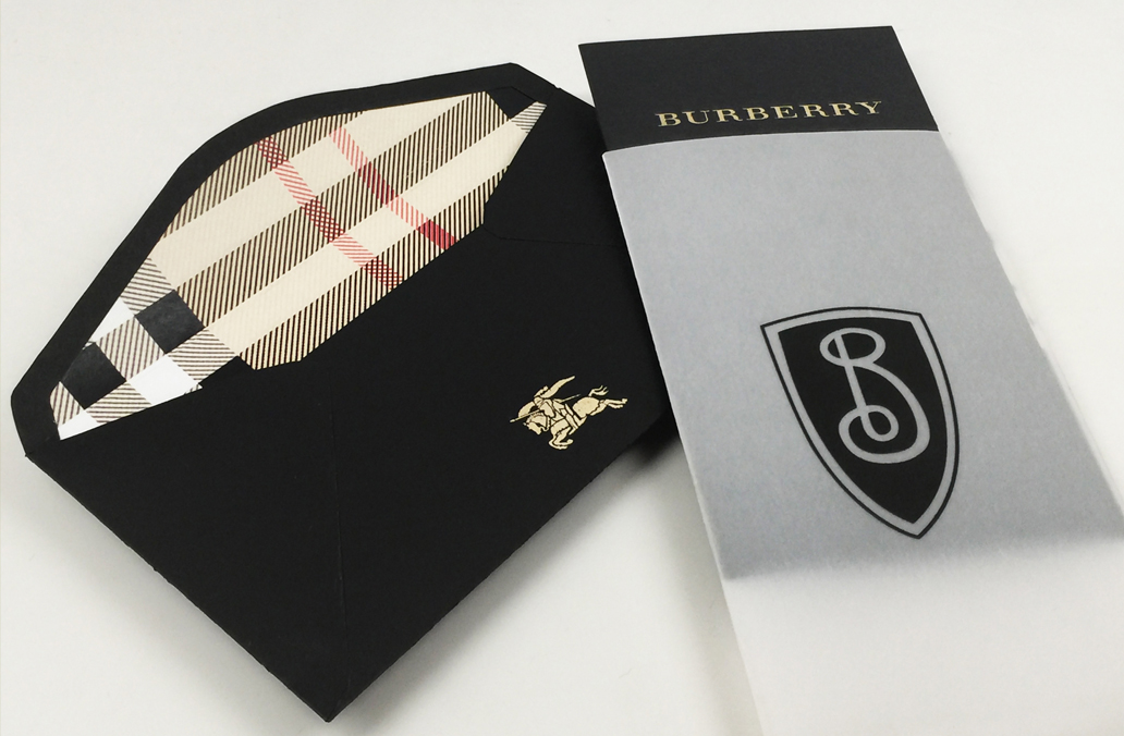 Hand made envelope with plaid pattern interior under lipped black layer and vellum sleeve